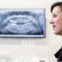 Dental professional beside a panoramic X-ray at ER Dental Pyes Pa, supporting accurate diagnosis, implant planning and modern dental care in Tauranga.