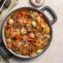 Coq au Vin- A traditional French dish of braised chicken in a red wine, bacon, onion, carrots & mushrooms.